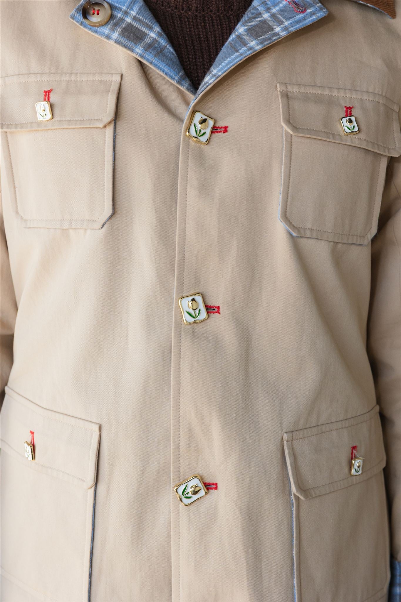 Close-up of a beige barn jacket with buttons and pockets on a white background power woman womens barn jacket power woman