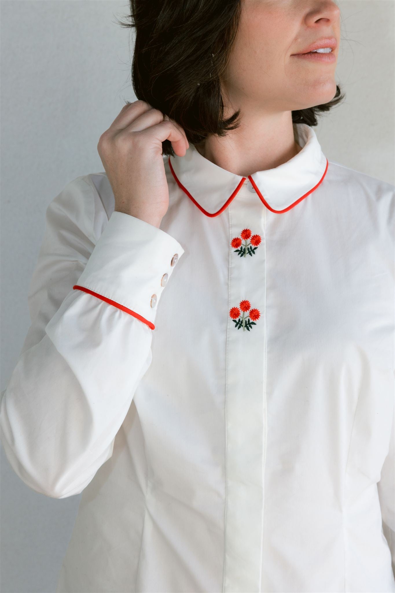 white blouse with red embroidery details
