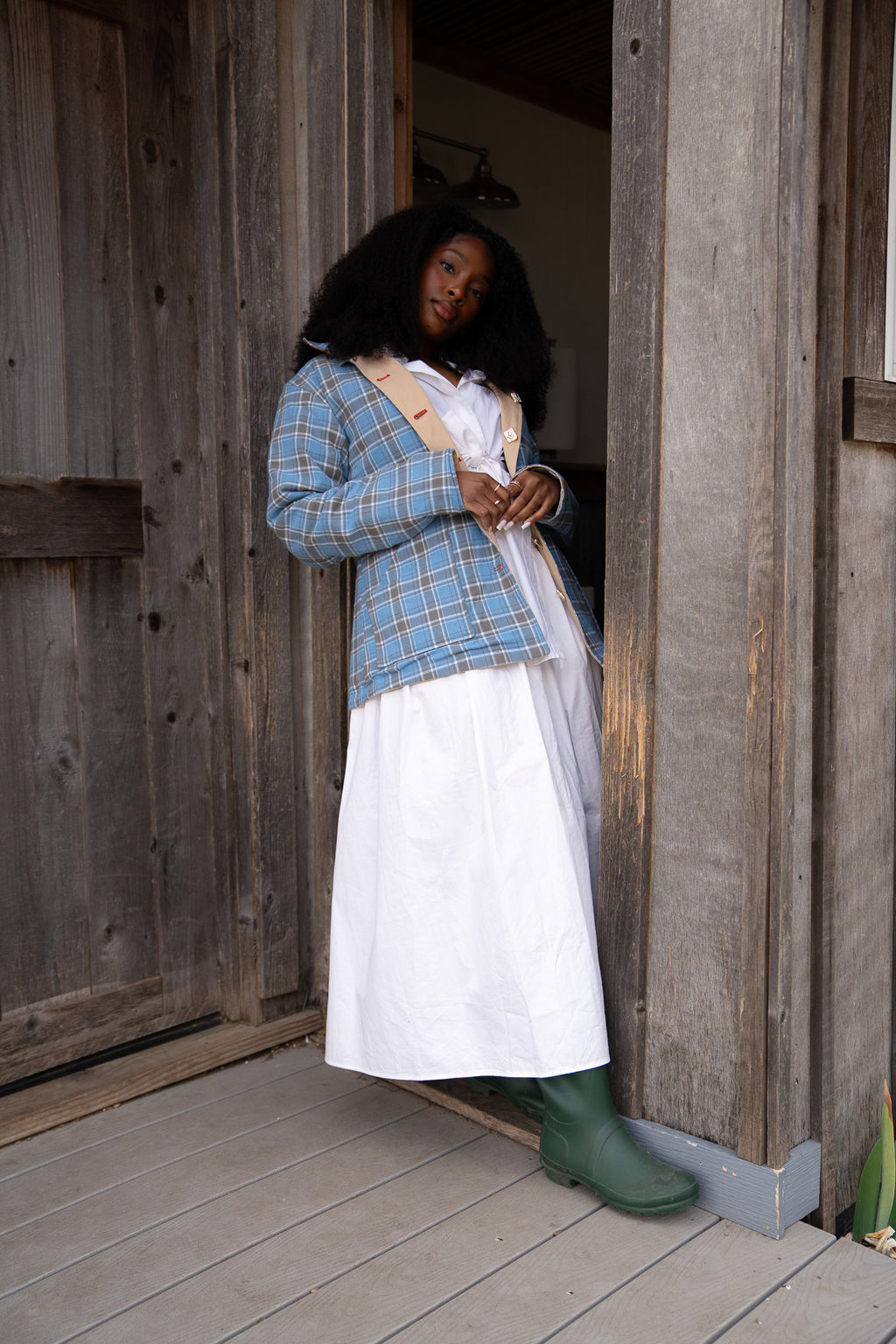 Person in historical attire standing in a wooden doorway womens barn jacket power woman