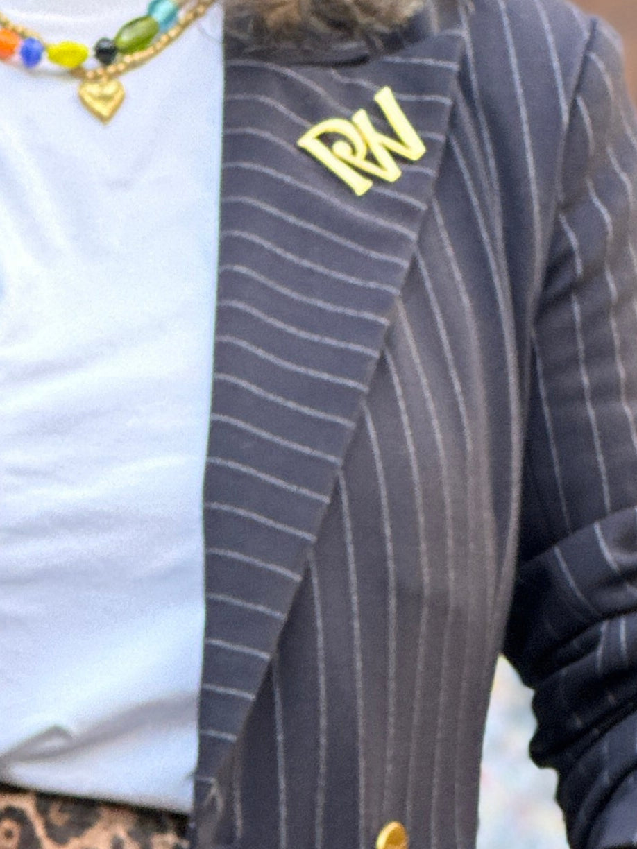 Woman in a striped blazer and cap with a blurred background