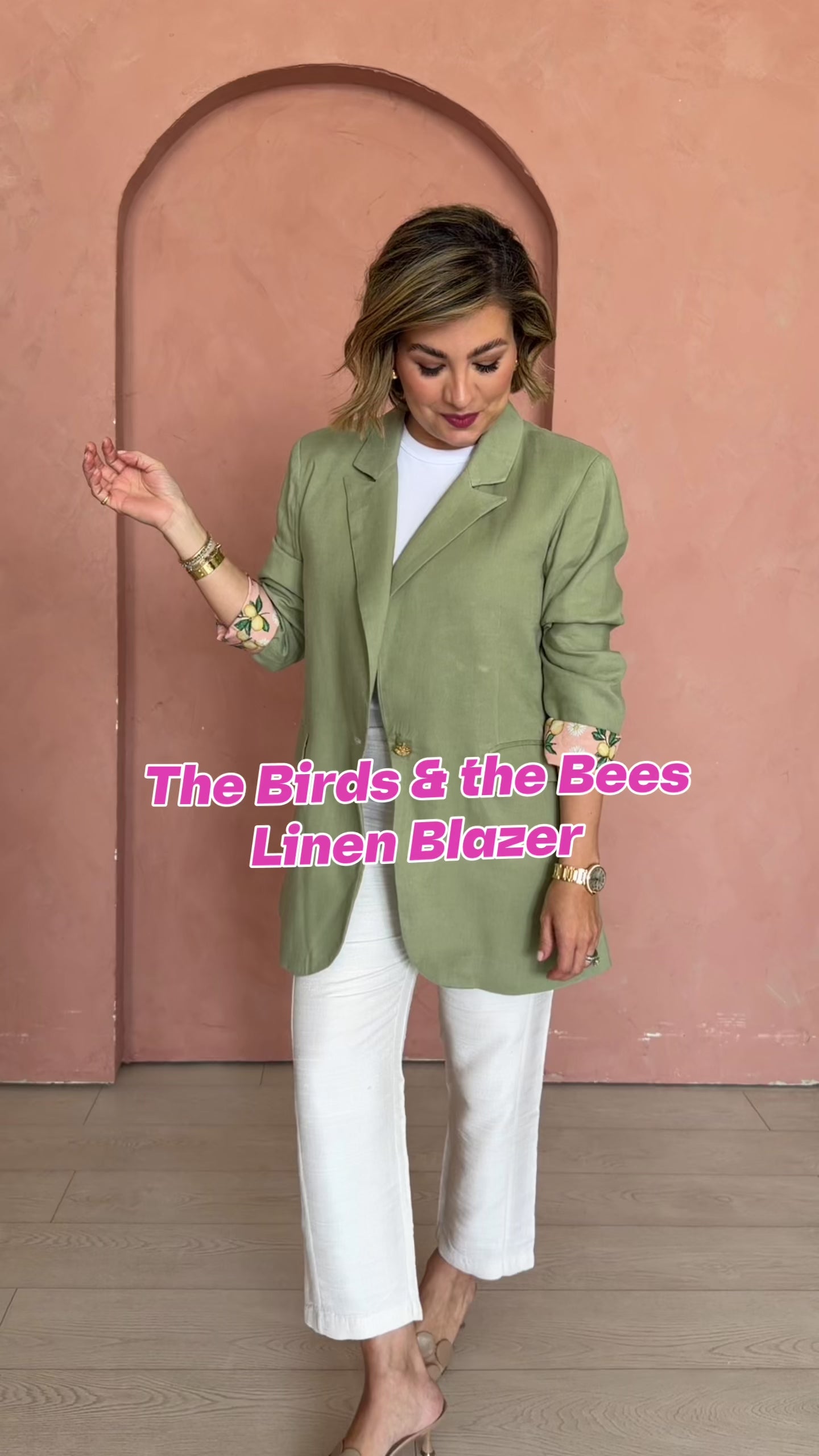 PWR WMN’s green Birds and the Bees Oversized Linen Blazer styled with white separates against a blush archway.